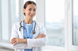 © New Africa - Nurse in medical uniform with stethoscope near window indoors