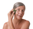 © New Africa - Beautiful woman doing facial massage with gua sha tool on white background
