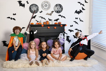 Sticker - Funny children in costumes for Halloween celebration in decorated room