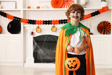 Poster - Funny boy with bucket dressed like pumpkin in room, space for text. Halloween celebration