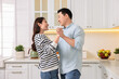 © New Africa - Happy lovely couple dancing together in kitchen