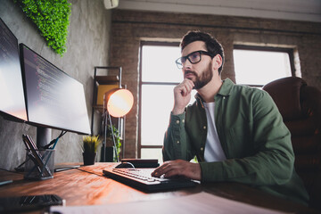 Canvas Print - Portrait of professional hacker young man brainstorming computer desk loft interior office indoors