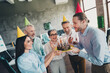 © deagreez - Portrait of group professional office workers congratulate colleague birthday cake loft interior business center indoors