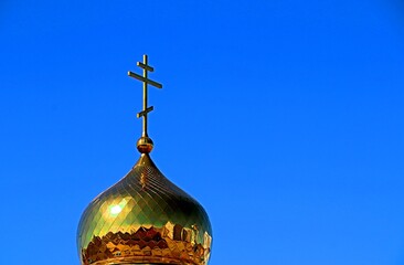 Gilded dome of the Orthodox church against the blue sky
