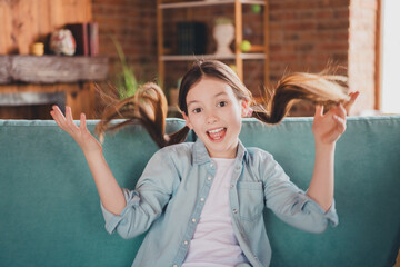 Canvas Print - Photo of lovely small girl couch throw hair wear shirt loft interior apartment indoors