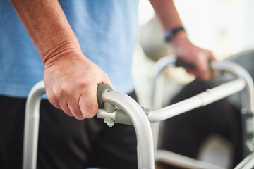 Canvas Print - Hands, physiotherapy and elderly man with walker for rehabilitation, senior care and gym workout. Balance, fitness and old person with mobility training, exercise and healthcare in retirement clinic