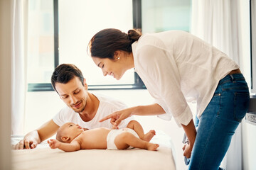 Poster - Mom, dad and newborn on bed for bonding with smile, love and happy parents in home for diaper change. Mother, father and baby in bedroom with support for growth, development and playful morning fun