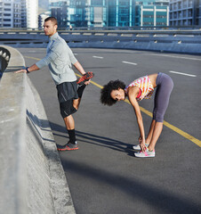 Canvas Print - Sports, bridge and couple stretching in city for running with race, marathon or competition training. Fitness, road and young man and woman athletes with warm up exercise for cardio workout in town.