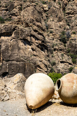 Wall Mural - old kvevri wine vessels near rock in Areni village