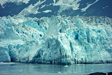 Detailed calving glacier in front of mountain landscape