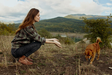 Serene Moment Woman Kneeling With Dog in Front of Majestic Mountain and Tranquil Lake on Travel Adventure