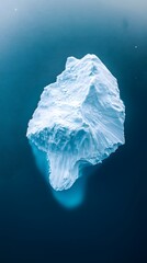 Wall Mural - an aerial view of an iceberg floating in the water, showcasing its massive size and intricate detail
