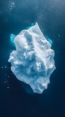 Wall Mural - an aerial view of an iceberg floating in the water, showcasing its massive size and intricate detail