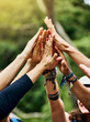 © SensSai/peopleimages.com - High five, hands and group of people outdoor with collaboration, motivation and solidarity for activity. Friends, trust and together in nature with cooperation, community or bonding for team building