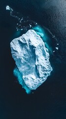 Wall Mural - an aerial view of an iceberg floating in the water, showcasing its massive size and intricate detail