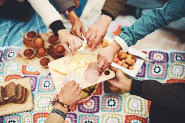 Food, picnic and snack table with people hands and fruit with bread and lunch for party and social event in park. Cheese board, sunshine and meal with meat, muffins and salami spread in summer