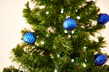 Christmas, celebration and tree with ornament in house for holiday, tradition and festivity in December. Bauble, shape and sparkling shine with decoration ball for xmas event, party and lights