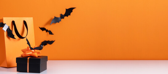 Wall Mural - Concept Halloween sale. Halloween decorations, bats on orange background. Happy Halloween,holiday discount. Flat lay, top view, copy space.