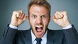 © angel_nt - A businessman in a suit is visibly furious, with clenched fists raised and a wide-open mouth showing his intense emotions. This moment captures his frustration in a corporate environment