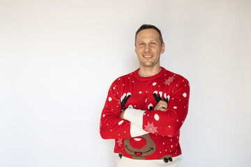 Young happy Caucasian man wears red knitted sweater smilling to camera isolated on white background. Happy New Year 2025 celebration Christmas holiday concept