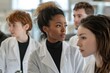 © Prism Trail - A woman in a white lab coat listening intently, surrounded by others