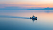 © Oksana - A fishing trawler moves across the calm sea, with soft pink and blue hues of the sunset creating an atmosphere of serenity and harmony