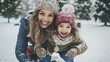 © Suleyman - A happy mother and her little daughter enjoy a snowy day in the park. The mother carries the girl on her back, they play chase, and slide down a hill on a sled.