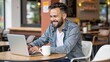 © Philippe - busy professional  business man working  on business  using laptop in cafe smile, smiling