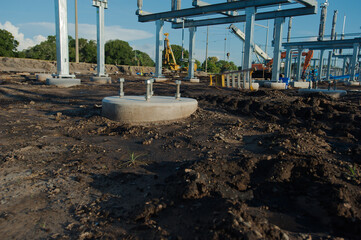 Wide view of  Electric substation under construction. Dirt piles from construction and equipment tire tracks with High Power Lines in Florida. Blue sky.  Upgrading infrastructure with large metal pole