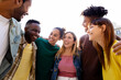 © Xavier Lorenzo - Young group of multiracial people having fun outside. United millennial student friends laughing while enjoying time together at city street. Youth community