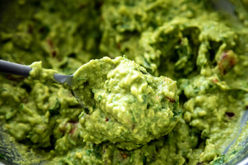 Traditional avocado guacamole and classic seasonings with corn tortilla nachos