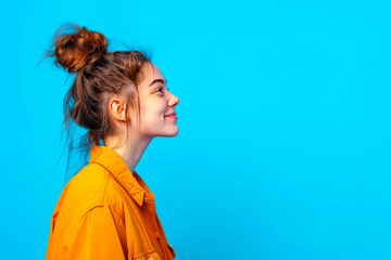 Profile side view portrait of attractive cheerful girl demonstrating copy space ad new isolated over bright blue color background