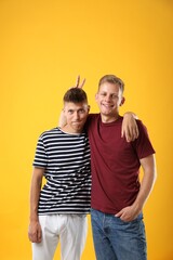 Poster - Portrait of funny brothers on orange background