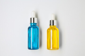 Wall Mural - Bottles of essential oils on white background, flat lay