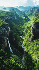 aerial view of a waterfall in a lush green mountain valley - nature photography stock image