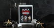 © Pixel-Shot - Tablet computer with Black Friday fashion sale advertisement, gift boxes, gadgets and shopping bags on dark wooden table