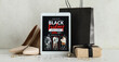 © Pixel-Shot - Tablet computer with Black Friday fashion sale advertisement, shoes, gift box and jewellery on white table
