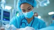 © pisan thailand - Portrait of a female medical professional either a doctor or nurse wearing blue scrubs and a face mask while standing in an operating room or surgical suite