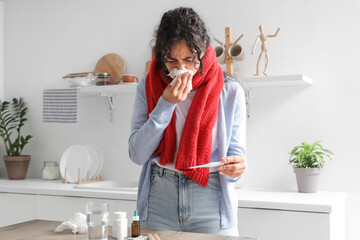 Sticker - Sick African-American woman measuring temperature at home