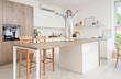 © Pixel-Shot - Cute little girl on high table in kitchen. Child at risk