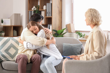 Wall Mural - Young couple hugging at psychologist's office