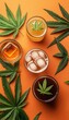 © WinThing - A colorful arrangement of four drinks surrounded by cannabis leaves on an orange background.