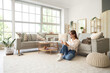 © Pixel-Shot - Beautiful young happy woman with cute cat and tablet sitting on floor at home