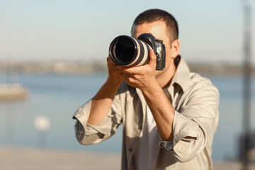 Wall Mural - Male photographer with modern camera outdoors