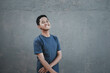 © Arief - A teenager wearing a t-shirt blushing shyly