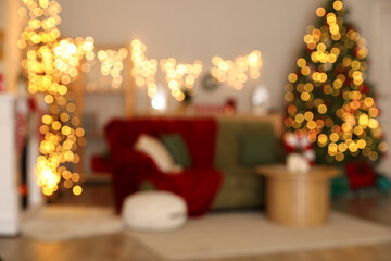 Sticker - Blurred view of festive living room with green sofa, glowing lights and Christmas tree