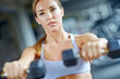 © ReeseBuyout4/peopleimages.com - Dumbbell, exercise and weightlifting with woman in gym for workout, performance and fitness. Weights, strong and sports athlete with person training and muscle for energy, wellness and health