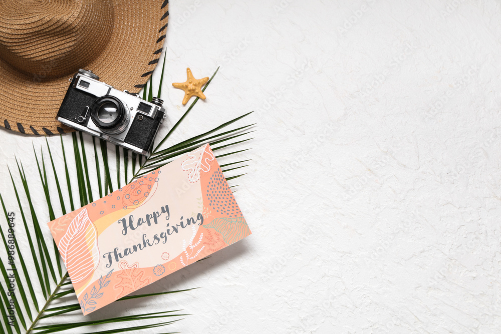Card for Thanksgiving Day with palm leaf, photo camera and hat on white background