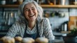 © Napasnan - Close-up of a grey-haired woman laughing while baking cookies in her kitchen, filled with delicious aromas.