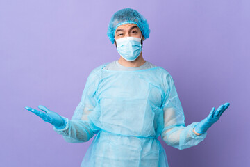 Wall Mural - Surgeon man with beard with blue uniform over isolated purple background having doubts